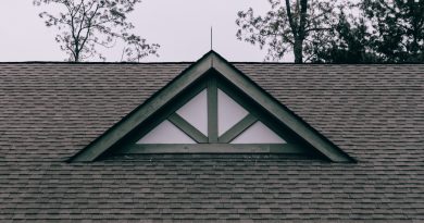 a roof with a triangle shaped window on top of it