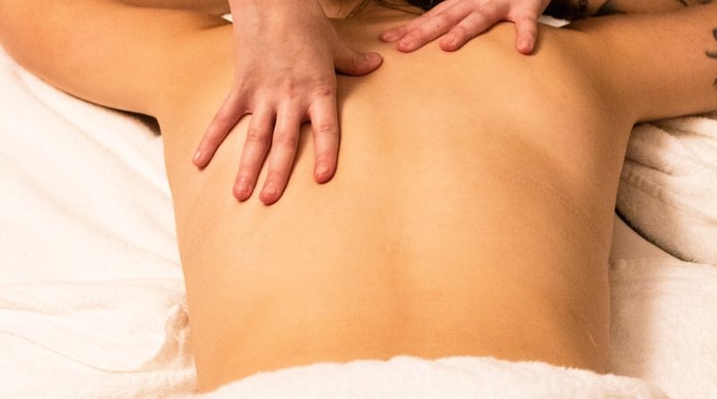 a woman getting a back massage at a spa