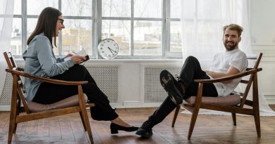Counselor and client in a positive therapy session in a well-lit room.