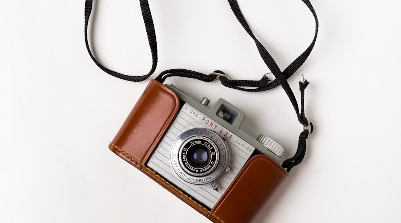 brown and gray SLR camera on white surface
