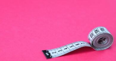 a measuring tape on a pink background